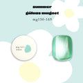 A Japanese cateye gel product listing for the Enoi Summer Glass Magnet Gel in the shade mg165. The image shows a round white potted gel with a teal glitter sample labeled 'mg165 énoi' and a larger, polished rectangular mint-green nail sample. 