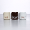 Three small jars from Professioal Japanese brand By En labeled 'Base Gel', '3-in-1 Base', and 'Top Gel'.